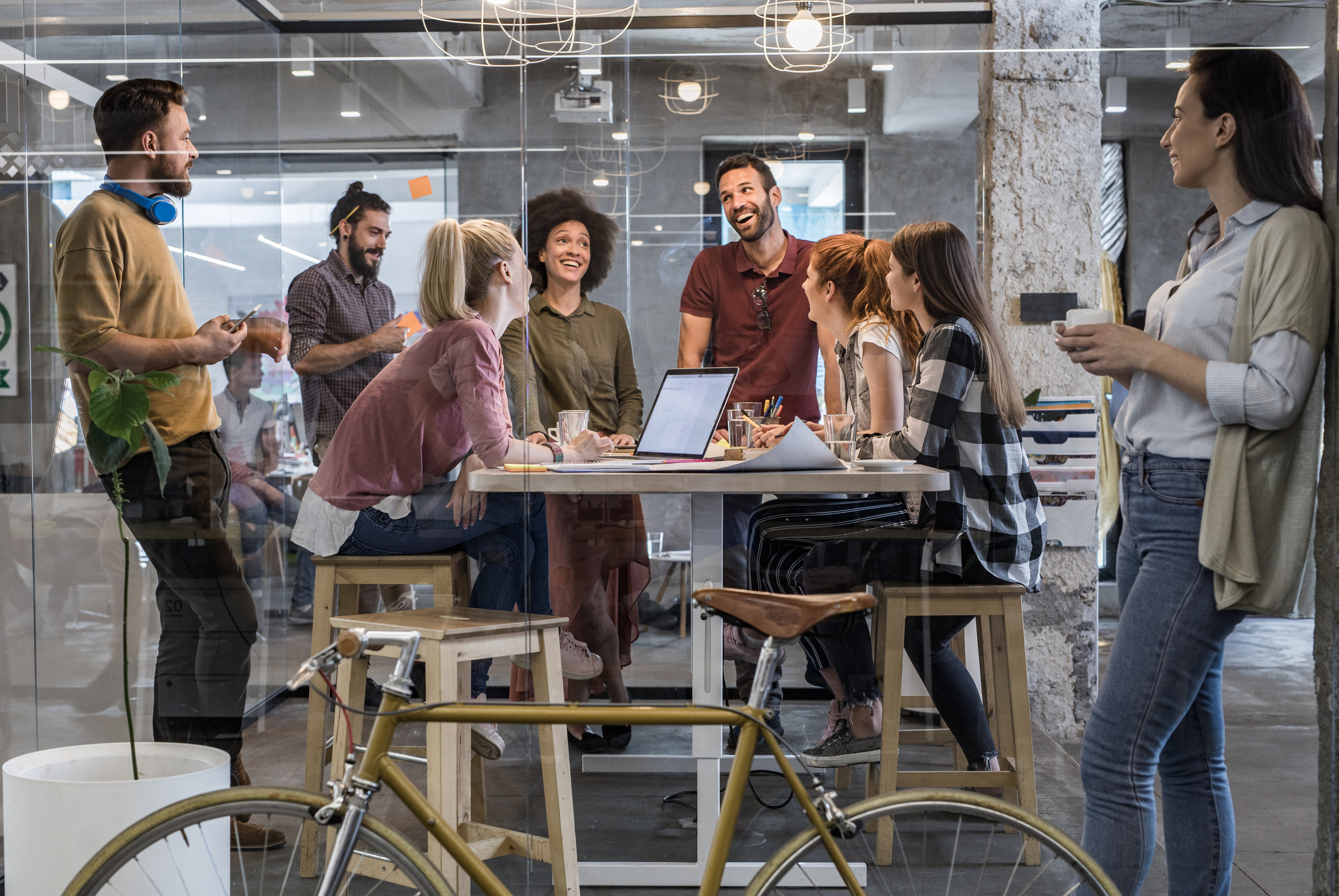 Happy freelance workers communicating while working at corporate office.