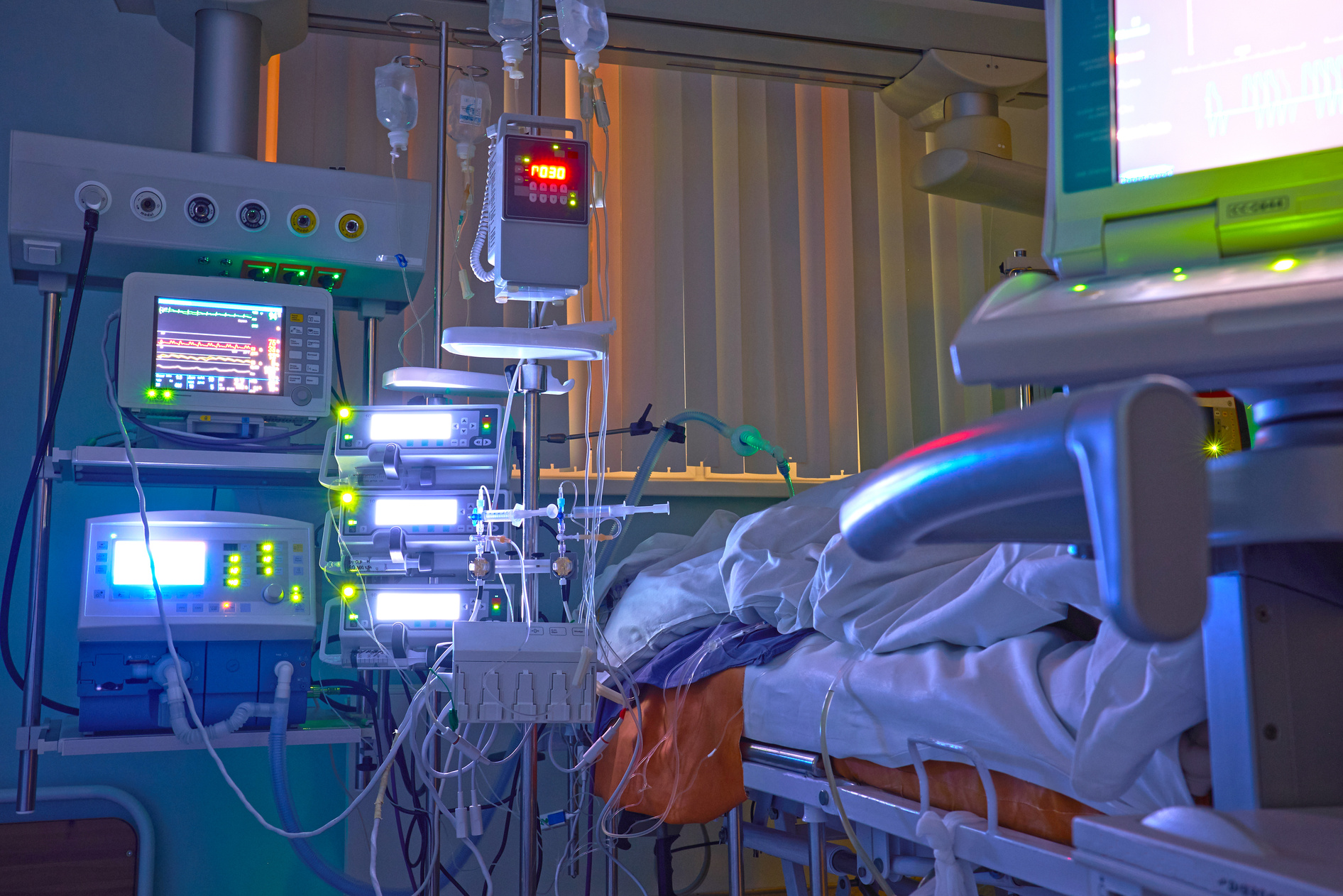 Glowing monitors in intensive care department. Nigth shift at icu, patient in critical state.